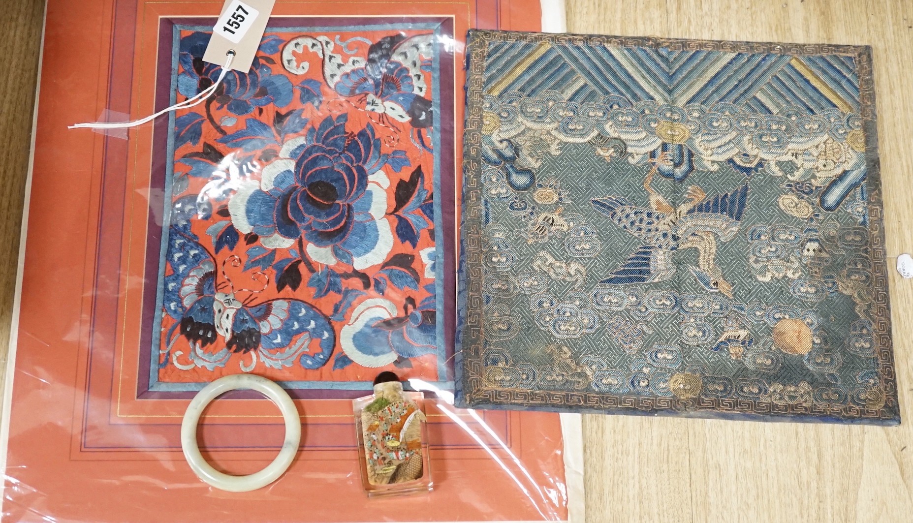 A Chinese embroidered silk Rank badge, mounted on a board, an inside painted snuff bottle, jade type bangle and a Chinese needlework pictures